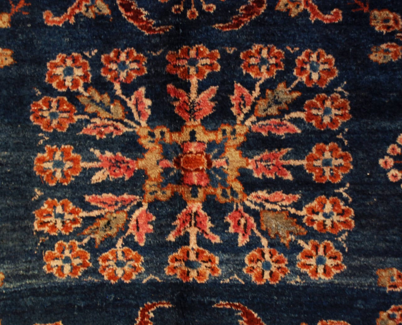 A beautiful early 20th century Persian Lilihan rug with an all-over field of flowers on a rich indigo background, surrounded but a crimson and floral border.