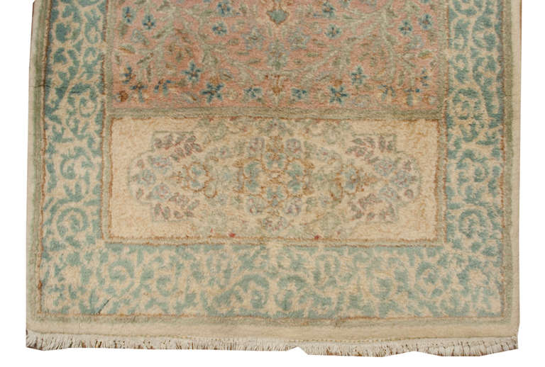 An early 20th century Persian Kirman runner with a wonderful soft color palette with an intricately woven floral pattern.