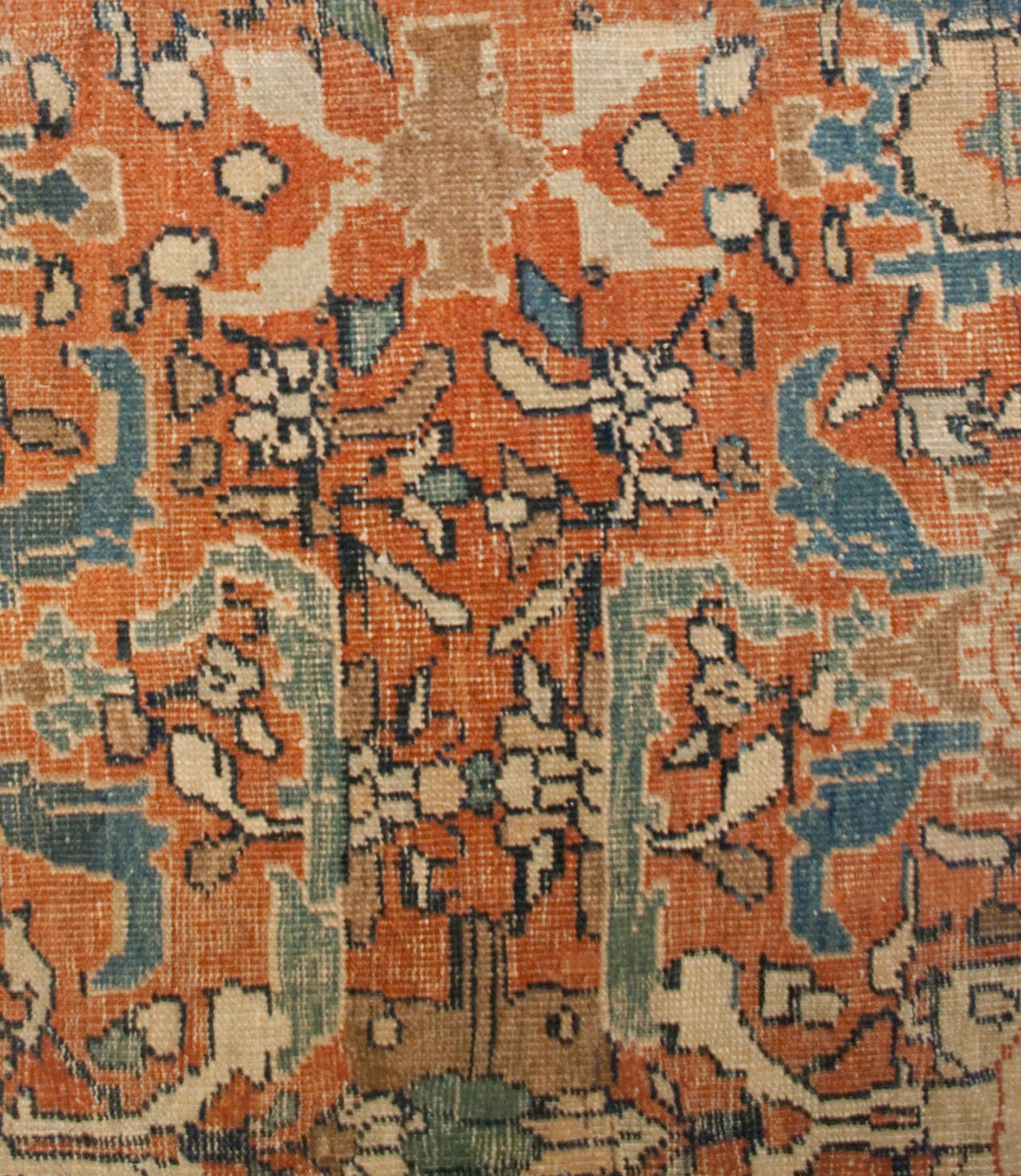 A late 19th century Persian Sultanabad rug with an absolutely beautiful large-scale Primitive floral pattern on a rust orange background, surrounded by a wide indigo border with large floral pattern.