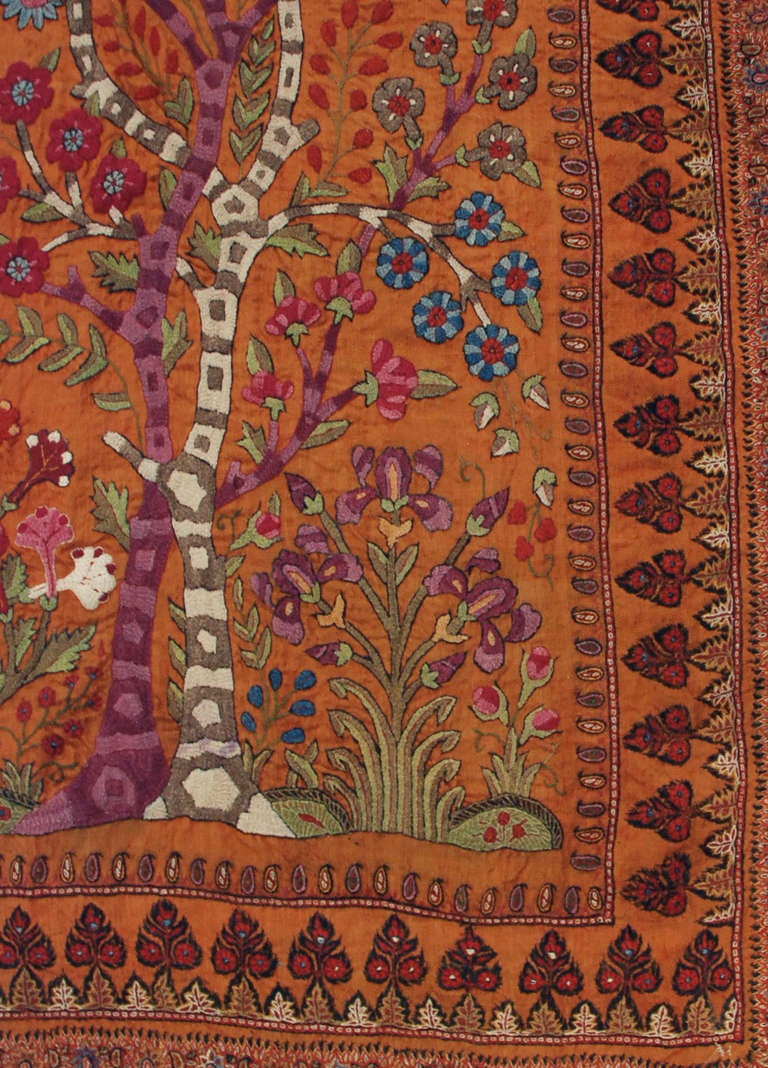 An unbelievable late 19th century Kirman silk embroidered Suzani textile depicting two entwined trees-of-life with flowering branches and surrounded by multiple borders. Measures: 2'9