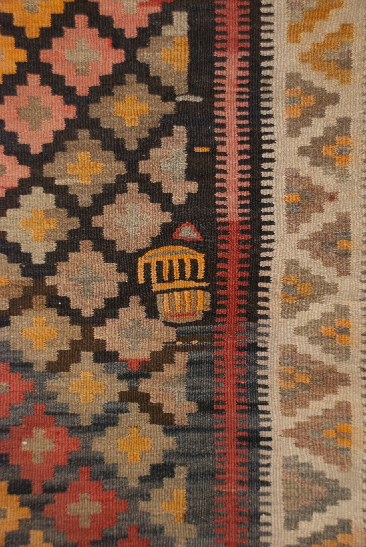 An early 20th century Persian Saveh runner with multicolored diamond pattern, surrounded by multiple contrasting borders.