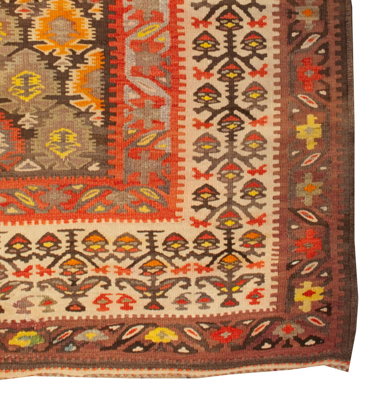 An early 20th century Persian Qazvin Kilim runner with a multicolored all-over tree-of-life pattern surrounded by multiple contrasting floral borders.