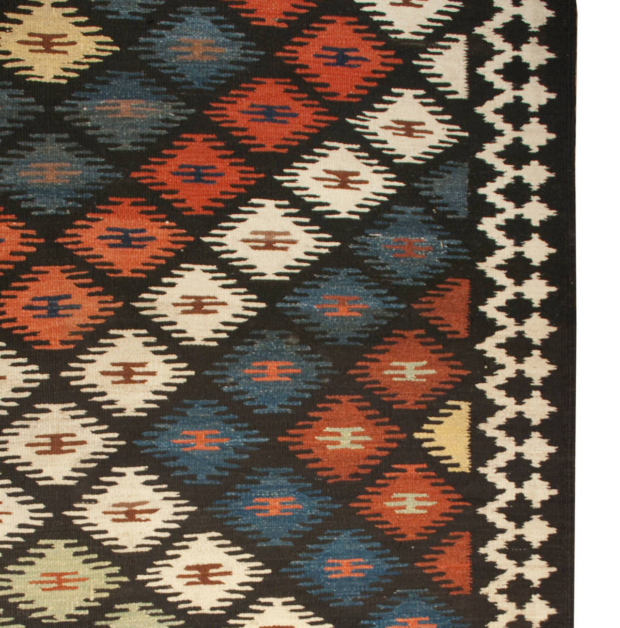 An early 20th century Persian Shahsavan Kilim runner with all-over multicolored diamond pattern surrounded by a contrasting geometric border.