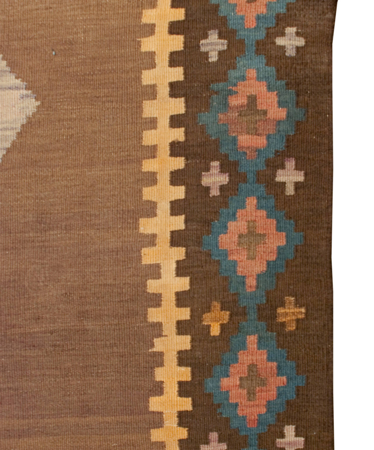 An early 20th century Persian Qazvin Kilim runner with multiple multicolored diamond medallions on a natural, undid, camel hair wool background, surrounded by multiple complementary geometric borders.