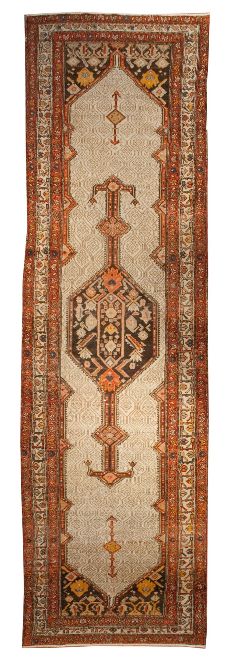 A late 19th century Persian Serab runner with large central geometric medallion on an intricately woven tone on tone background, surrounded by multiple contrasting floral borders.