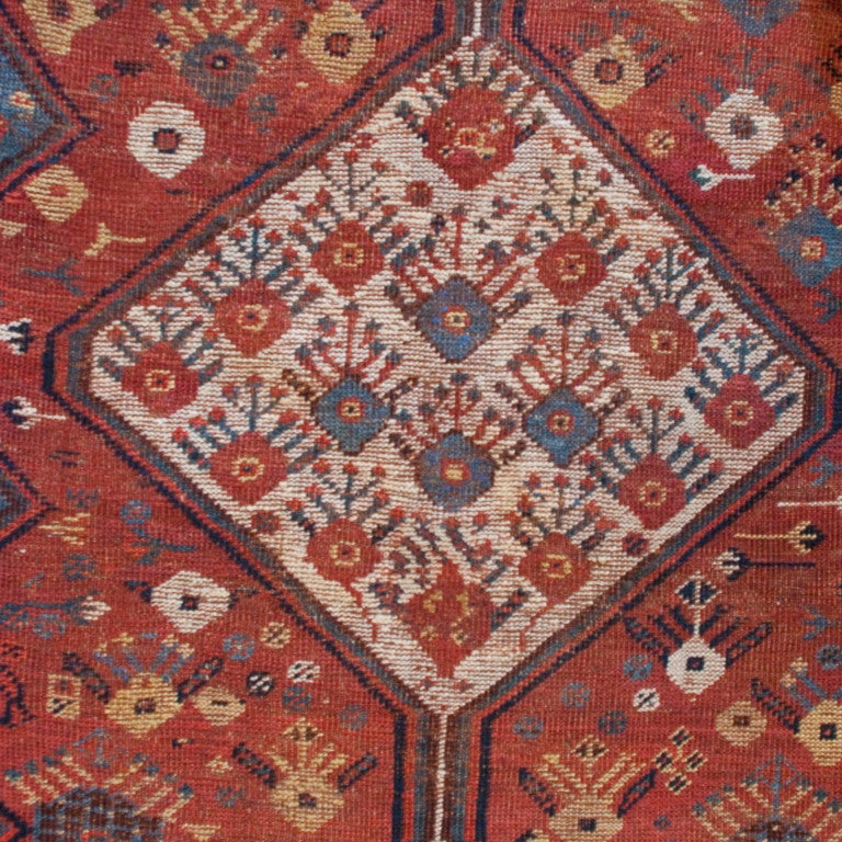 A 19th century Persian Ghashghaei carpet with a central diamond medallion with tree of life motif and a paisley patterned border.



Measures: 4.6