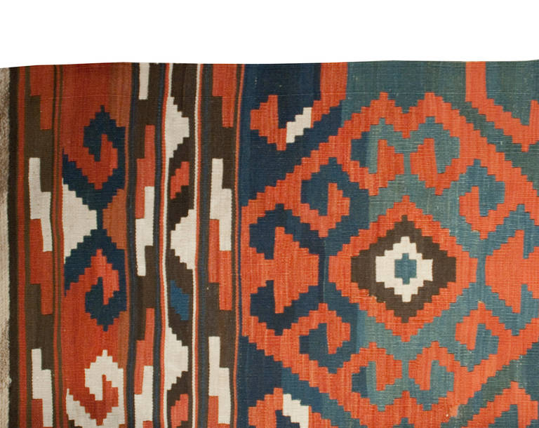 A 19th century Azerbaijani Kilim rug with an amazing alternating geometric striped pattern in crimson, emerald and cream, with no border.