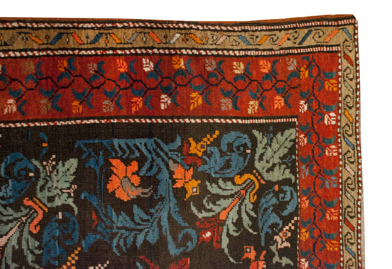 A wonderful 19th century Russian Karabagh rug with a beautiful large-scale floral pattern on a black background, surrounded by multiple wonderful complementary floral borders.