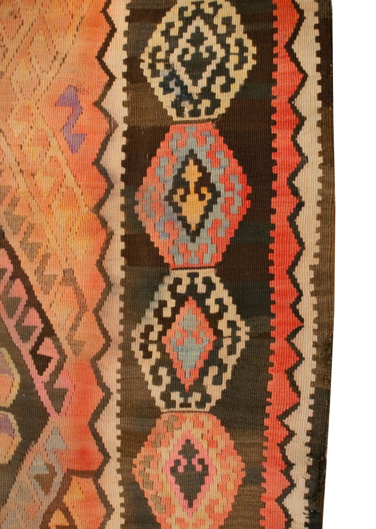 An early 20th century Anatolian Turkish Kilim runner with three large multicolored geometric central medallions, surrounded by multiple complementary geometric borders.