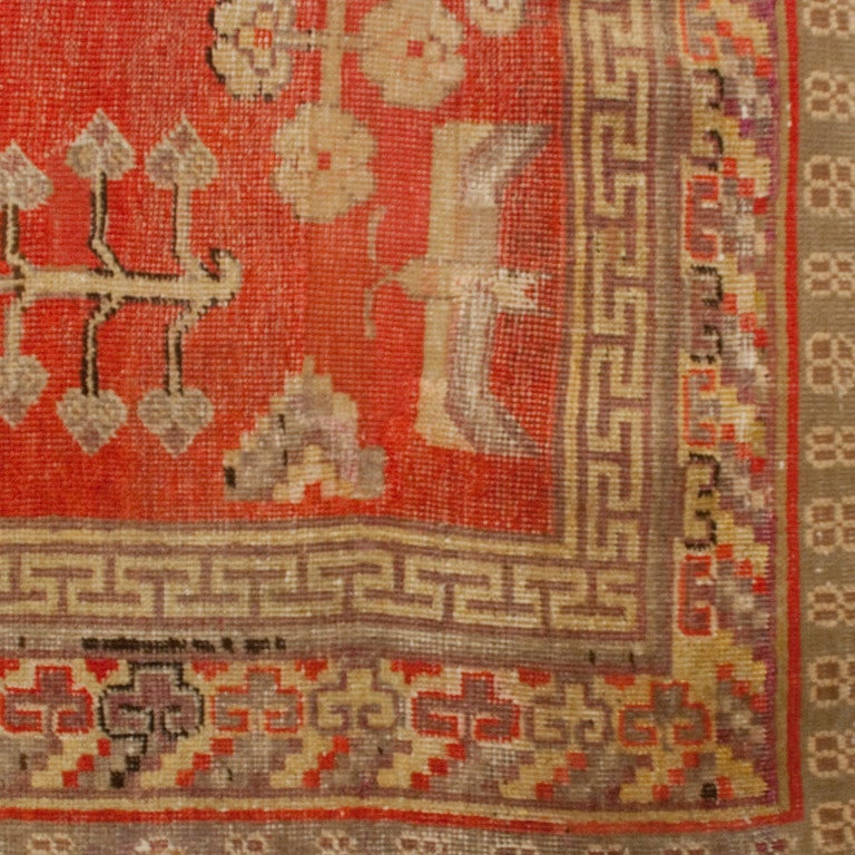 An early 20th century Central Asian Samarghand carpet with three central medallions in a field of pomegranates and buzzing bees, surrounded by a multi layered border.



Measures: 9.6