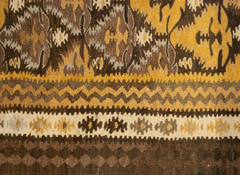 An early 20th century Persian Qazvin Kilim runner with an all-over diamond floral pattern surrounded by multiple complementary geometric borders.