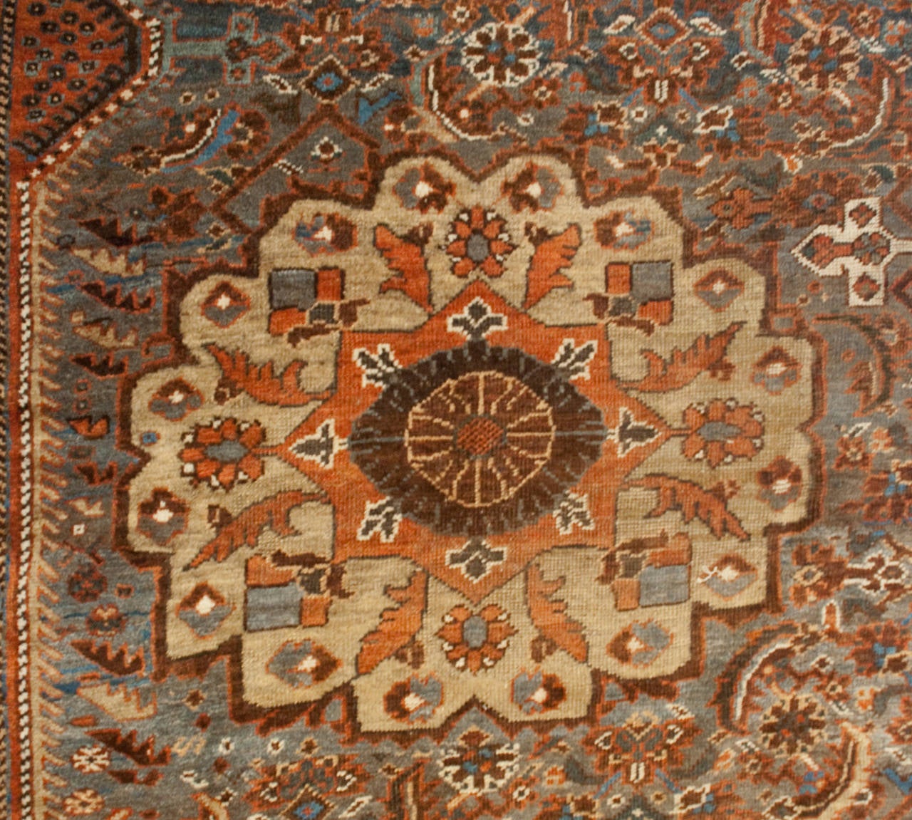 A late 19th century Persian Gashgai rug with an unbelievably dense field of flowers with multiple floral medallions surrounded by multiple floral borders.