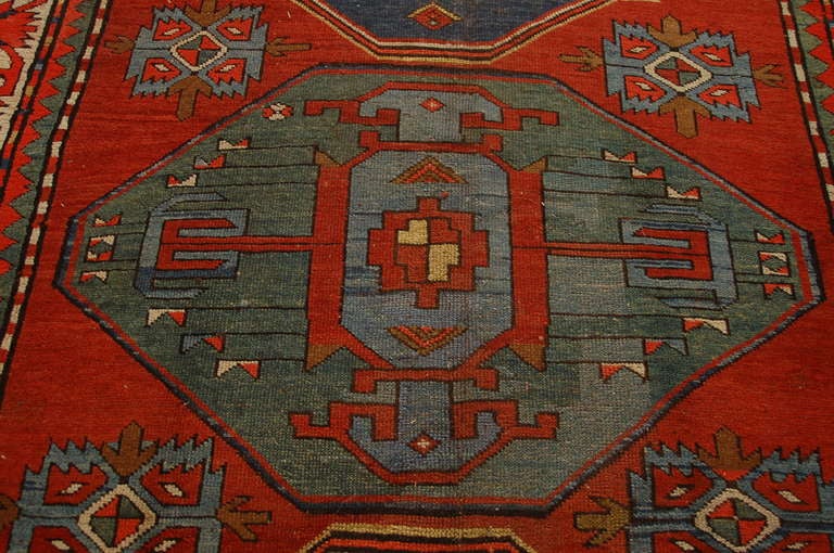 A late 19th century Russian Kazak rug with three geometric medallions on a crimson background surrounded by a contrasting geometric border.



Keywords: Rug, carpet, Persian, Central Asian, Tabriz, Heriz, Serapi, Bakshaish.