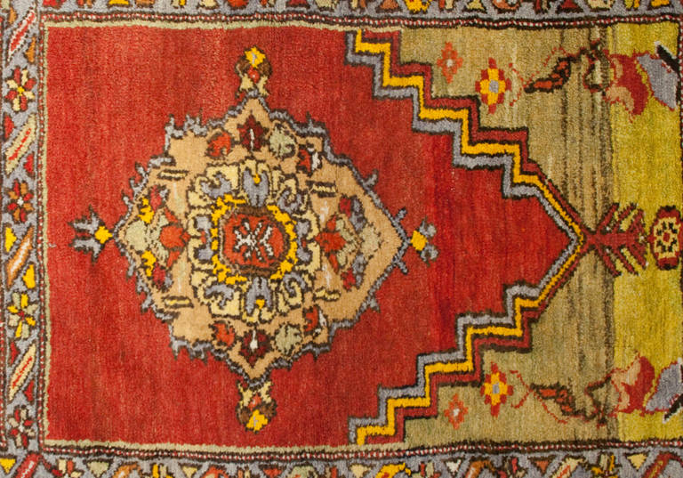 An early 20th century Turkish multicolored Oushak prayer rug with multiple geometric designs surrounded by multiple complementary borders.