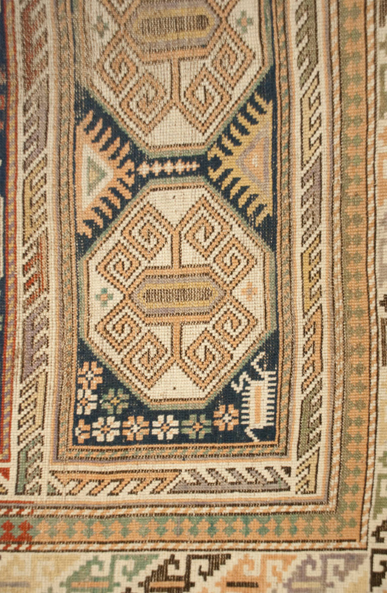 A 19th century Persian Shirvan rug with bold octagonal medallions on an indigo background, surrounded by multiple complementary geometric border.