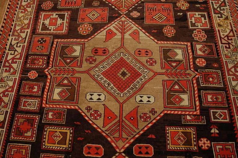 A late 19th century Persian Karebak rug with large geometric medallions amidst a field of flowers and animals, on a natural background, surrounded by multiple contrasting geometric borders.

Keywords: Rug, carpet, textile, Serapi, Tabriz, Heriz,