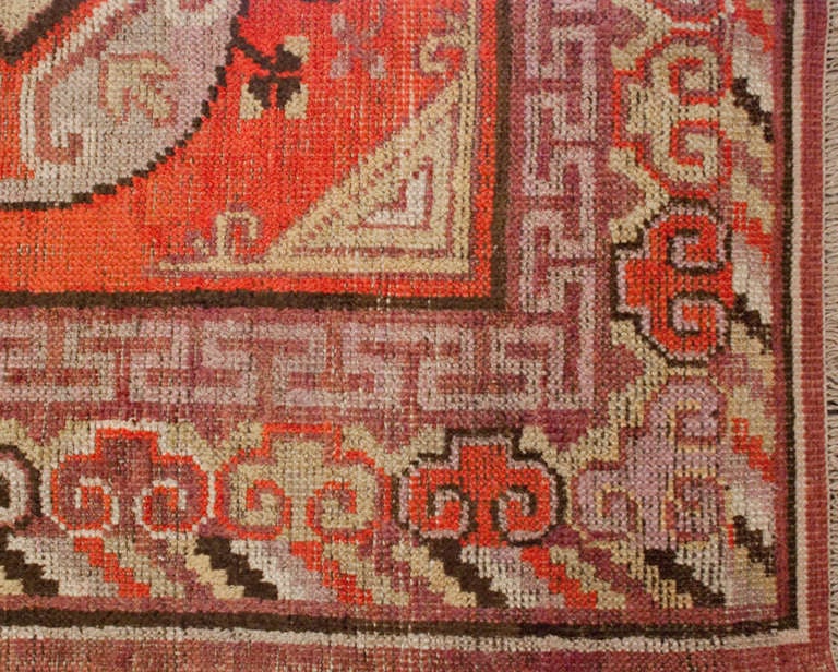 A late 19th century Central Asian Khotan rug with two circular and one square medallion on a crimson background, surrounded by a cloud border.

  

Keywords: Rug, carpet, textile, quilt, wall hanging, Samarkand, Khotan, Persian.