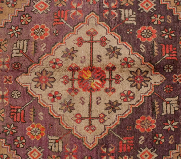 An early 20th century Central Asian Khotan rug with central diamond and floral medallion on a violet background, surrounded by multiple floral borders.

Reza's Rug Gallery #: RH1116.

Keywords: Rug, carpet, Khotan, Samarkand, Yarghand, Heriz,