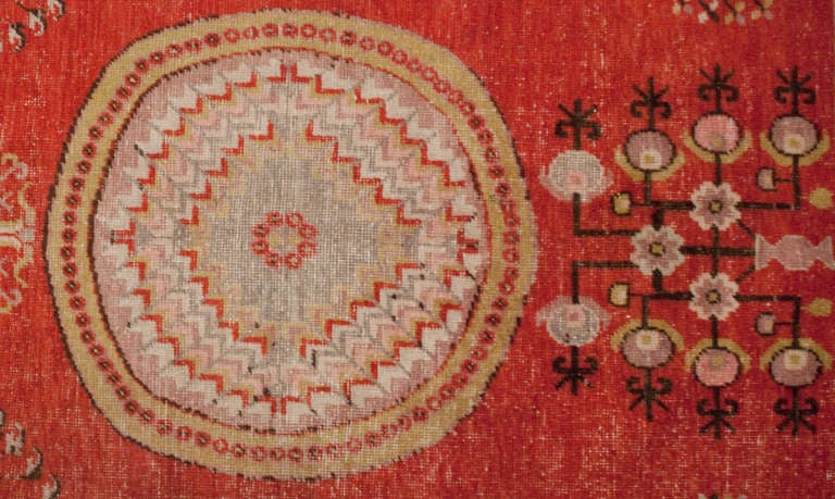 An early 20th century Central Asian Khotan rug with three central medallions amidst a field of flowers on a crimson background surrounded by multiple floral borders.

Reza's rug gallery #: A0543.

Keywords: Rug, carpet, Khotan, Samarkand,