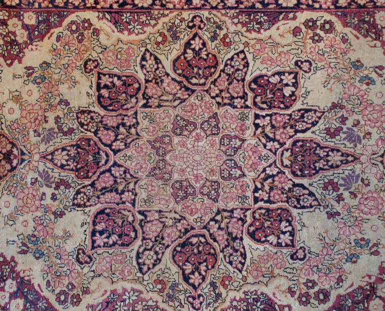 A wonderful 19th century Persian Kermanshah rug with a beautiful floral central medallion on a field of flowers surrounded by multiple complementary floral borders.