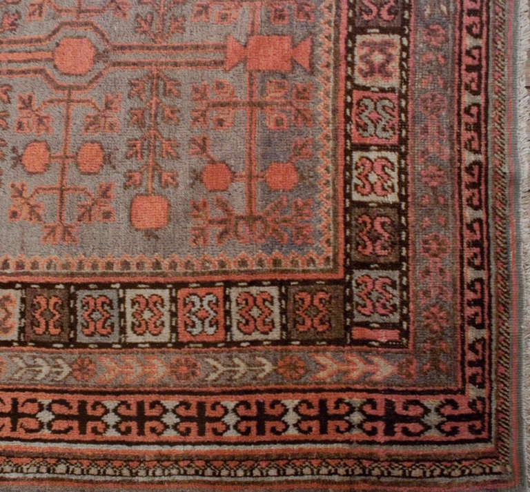 An n early 20th century Central Asian Samarkand rug with all-over pomegranate pattern on a pale indigo background surrounded by multiple floral borders.

Keywords: Rug, carpet, Samarkand, Khotan, Heriz, Serapi, Tabriz.