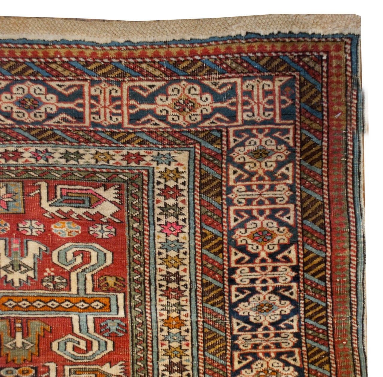 A late 19th century Perepedil rug with a beautiful all-over field of geometric patterns on a crimson background surrounded by an elaborate complementary multicolored geometric border.