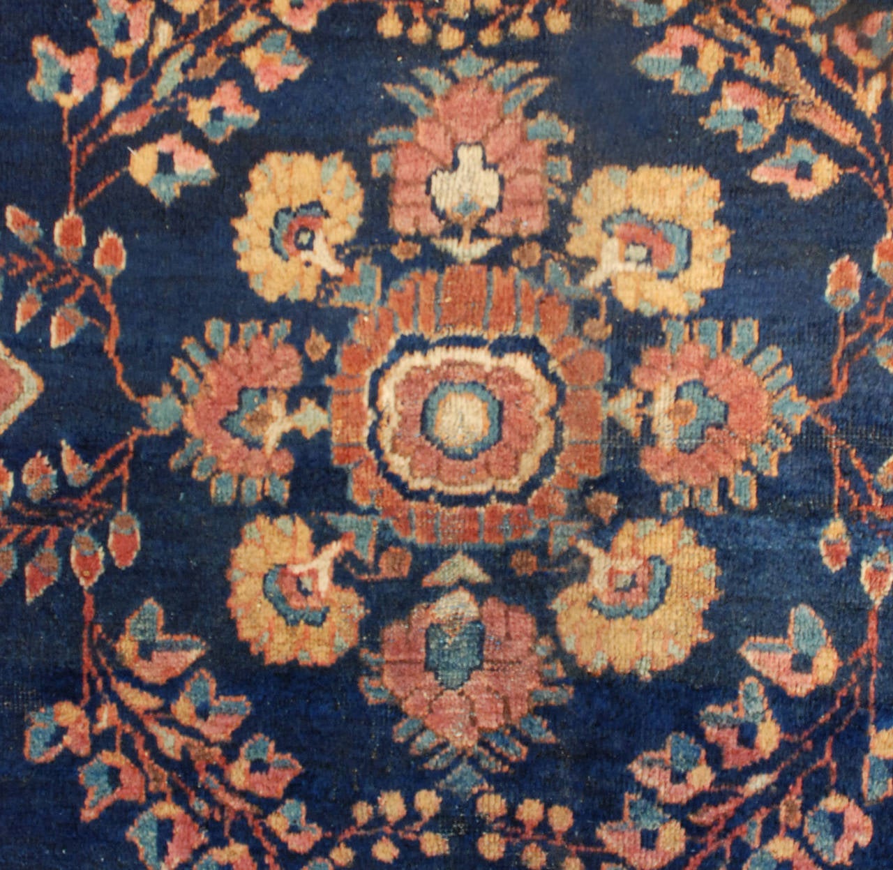 A wonderful 19th century Persian Mahal rug with a beautiful all-over floral pattern on an indigo background, surrounded by multiple contrasting floral borders.