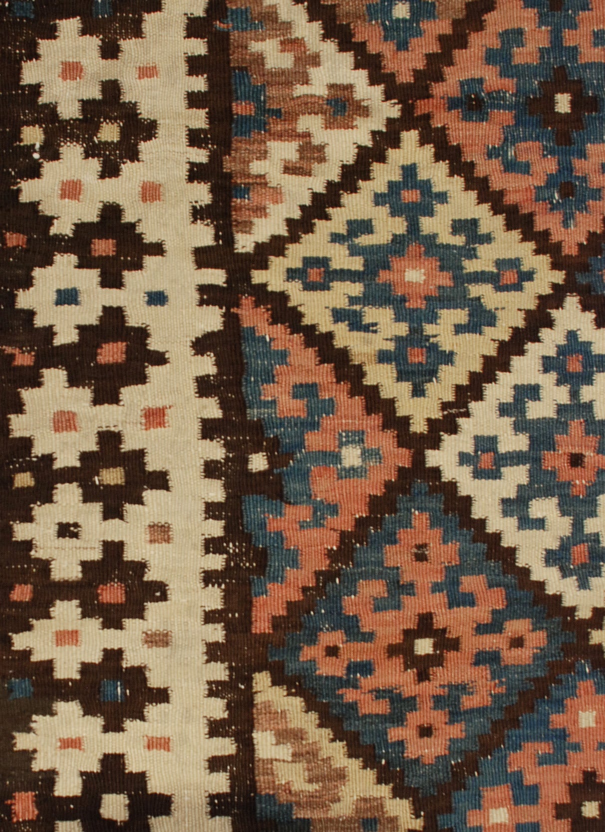 An early 20th century Persian Saveh Kilim runner with an all-over multicolored diamond pattern, surrounded by a complementary geometric border.
