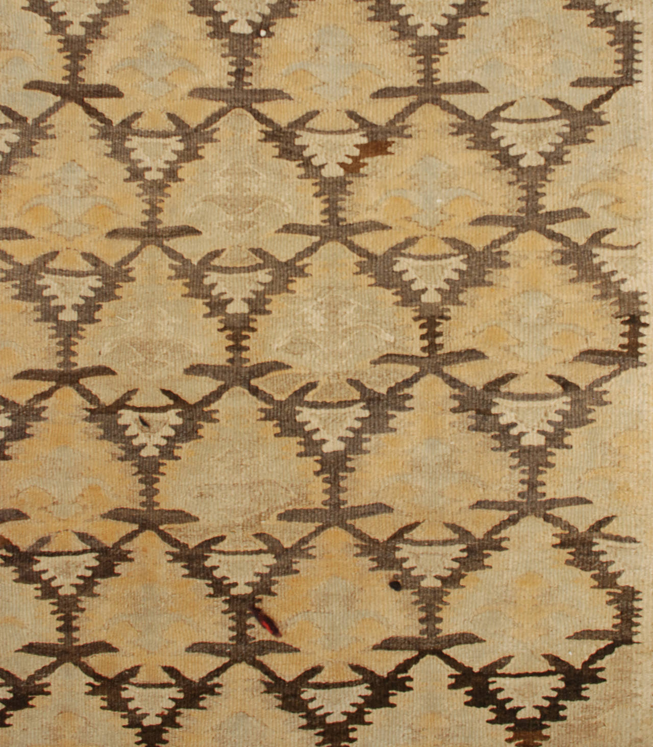 An early 20th century Persian Qazvin Kilim runner with an all-over floral pattern on a brown ground, surrounded by a complementary geometric border.