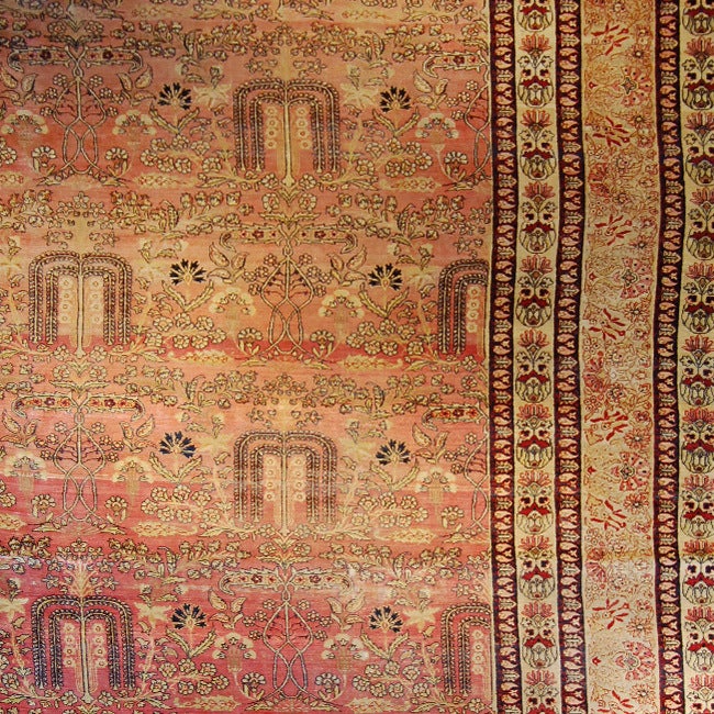 Un tappeto persiano Kirmanshah monumentale e mozzafiato con motivi floreali e di salice (simbolo persiano dell'amore) ripetuti su uno sfondo rosa pallido con un bordo floreale alternato. 
