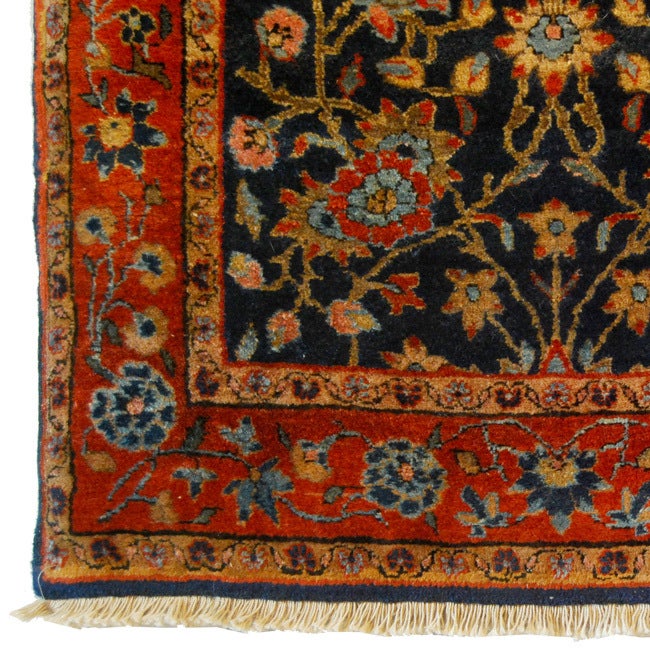 A 19th century Persian Sarouk Mahajan carpet with scrolling vines and flowers on an indigo background surrounded by a rich crimson floral border.  <br />
<br />
Reza's Rug Gallery #:  R4076<br />
<br />
<br />
Keywords:  Rug, carpet, textile,