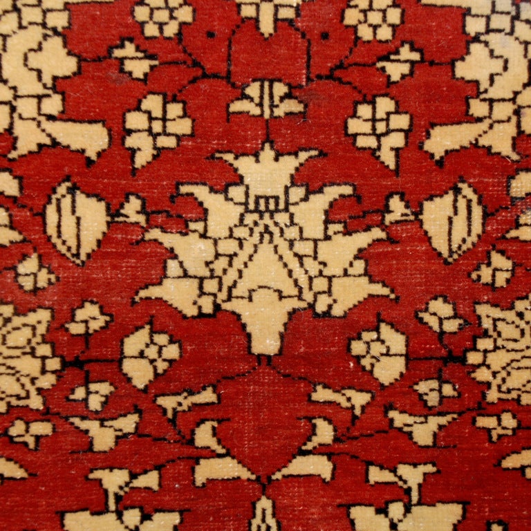 A 19th century Persian Saruk Farahan carpet with central floral medallion on an indigo background inside a crimson frame with a contrasting scrolling vine and floral border. Measure:3'7