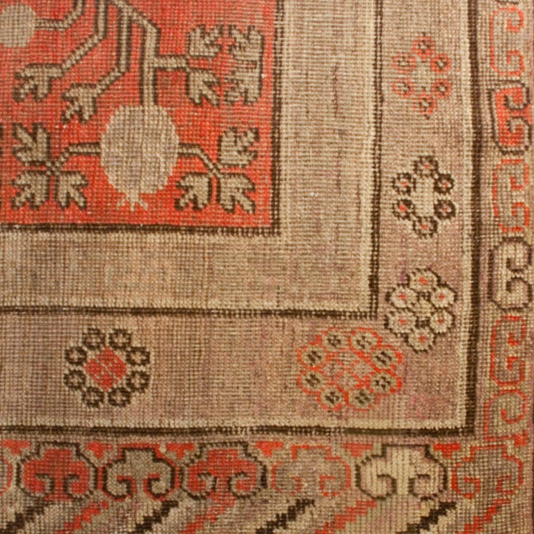 An early 20th century central Asian Samarghand carpet with pomegranate and vine motif on a muted red background surrounded by alternating floral borders.



Measures: 12'2