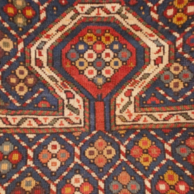 A 19th century Persian Kuba prayer carpet with central field of flowers on an indigo background, surrounded by several floral borders.



Measures: 4.8