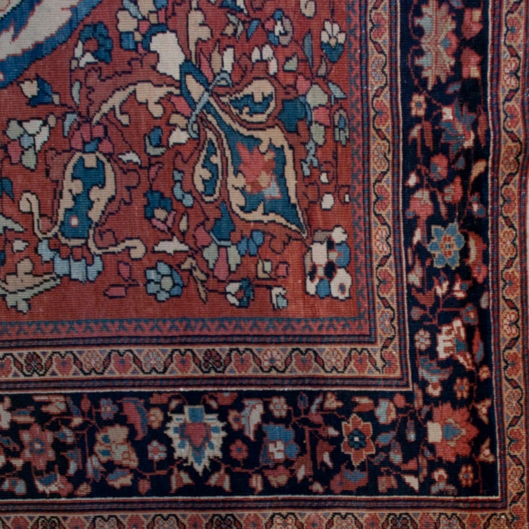 A 19th century Persian Saruk Farahan carpet with oval medallion on a pale red floral background, surrounded by a contrasting floral border.



Measures: 10' x 6'9