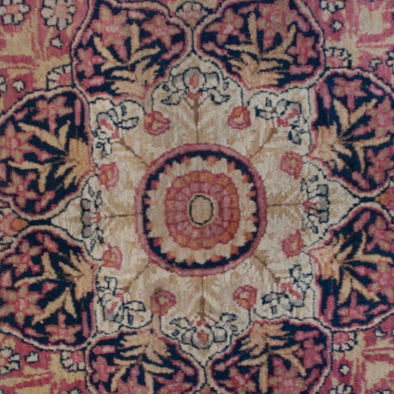 A 19th century Persian Kirmanshah carpet with large central medallion on a floral and vine motif background surrounded by several alternating contrasting borders.



Measures: 8'3