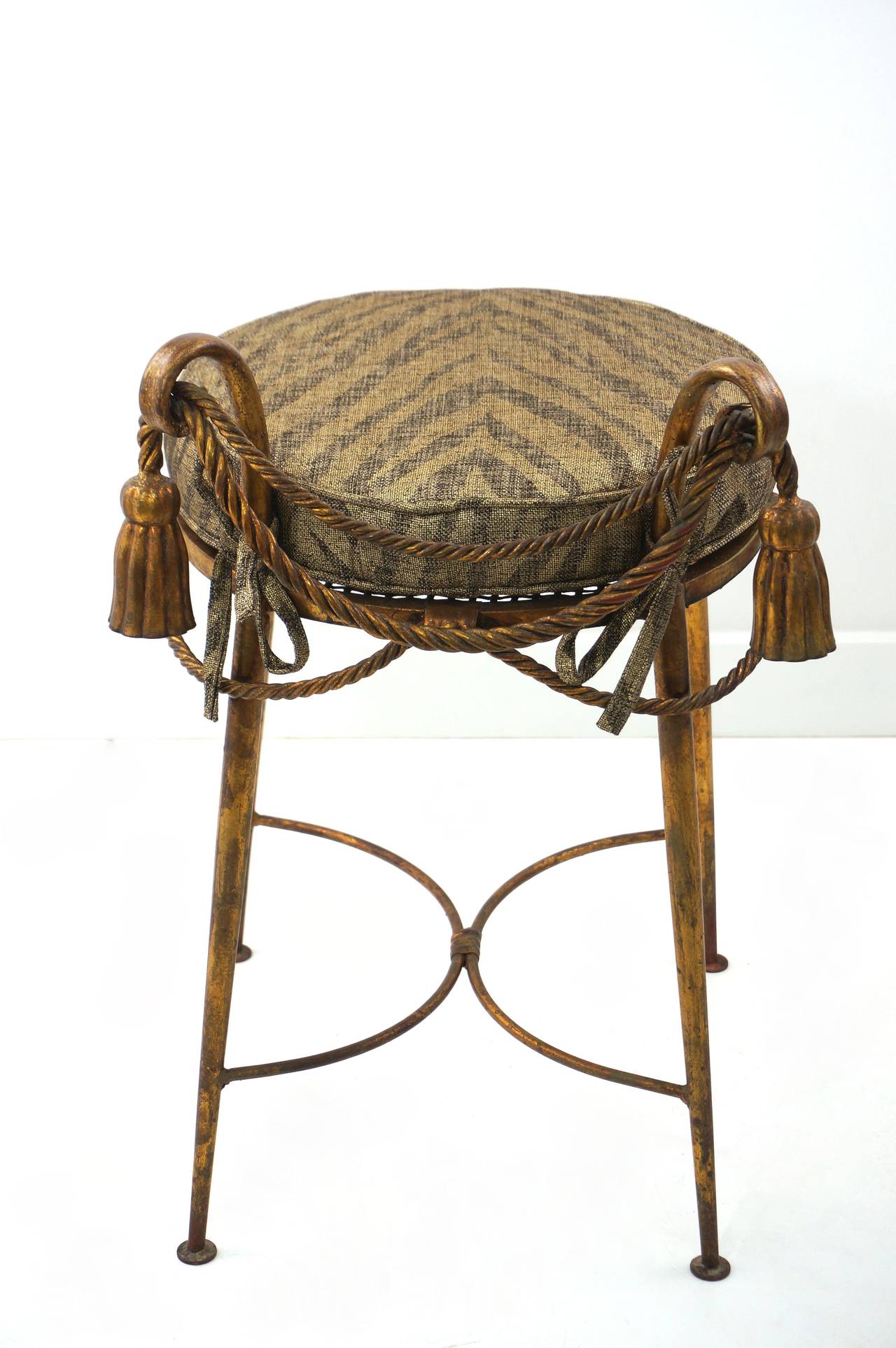 Mid-Century gilded iron vanity stool with rope and tassel details and a custom-made tiger pattern cushion, not shown. Contact dealer for photos.

Please feel free to contact us directly for the best price, a shipping quote or any additional