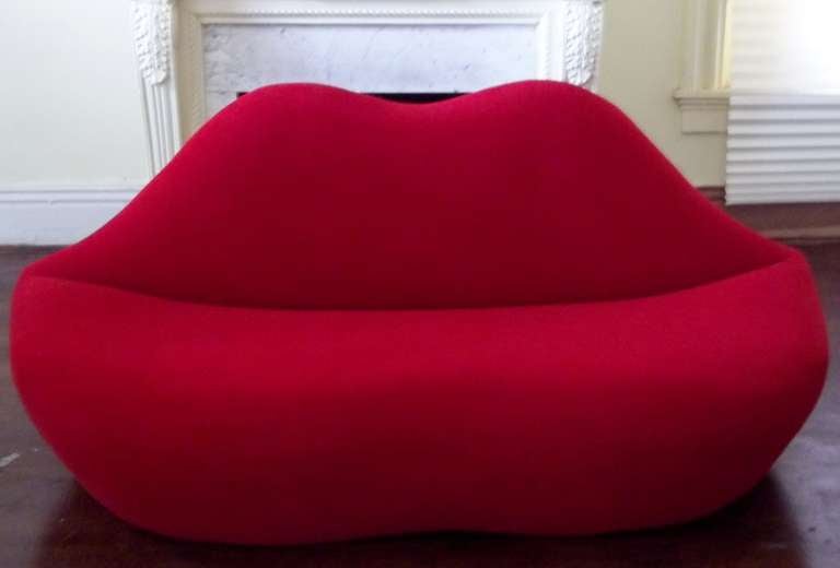 Original concept was a 1937 surrealist sofa by Salvador Dalí. That wood-and-pink satin sofa was shaped after the lips of actress Mae West, Dali found her fascinating tho' the sofa was a commissioned piece. Later pop culture of the 1960's and 1970's 