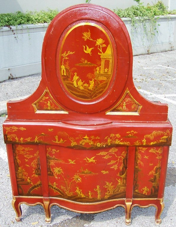 A rare one-of-a-kind red & gilt decorated vanity in English chinoiserie or japanning . Very crisp and detailed gilt decorations.
Three top working drawers over flanking cabinets doors (configured as 3 faux drawer fronts each ).
Dressing mirror