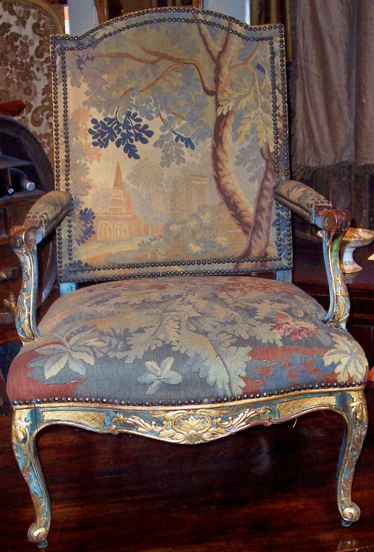 A 19th century painted and partially gilded Regence styled walnut armchair or fauteuil . The paint broken down into base pigments, gilt in good shape considering age and use. The thick antique Flemish tapestry in very good shape with seat , back and