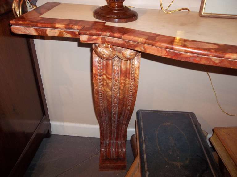 The well carved plinths supporting a slightly front bowed top with Carrera marble inset . As with most veined marble , uneven bits and veining and variances in color through out .