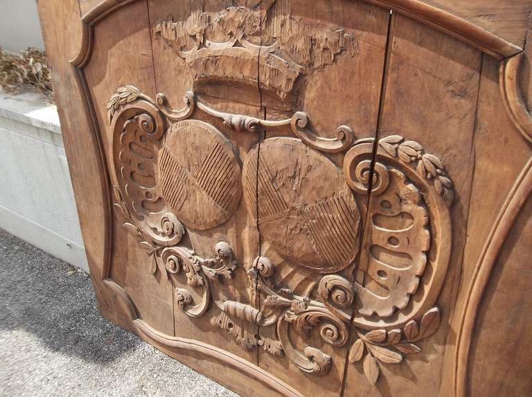 A massive and very faded walnut panel (probably over mantle piece ) with carved armorial inset. Mortise and tendon construction (note upper corners and top groove) and pegged board construction . Rich walnut color if resealed or oiled (note, photos