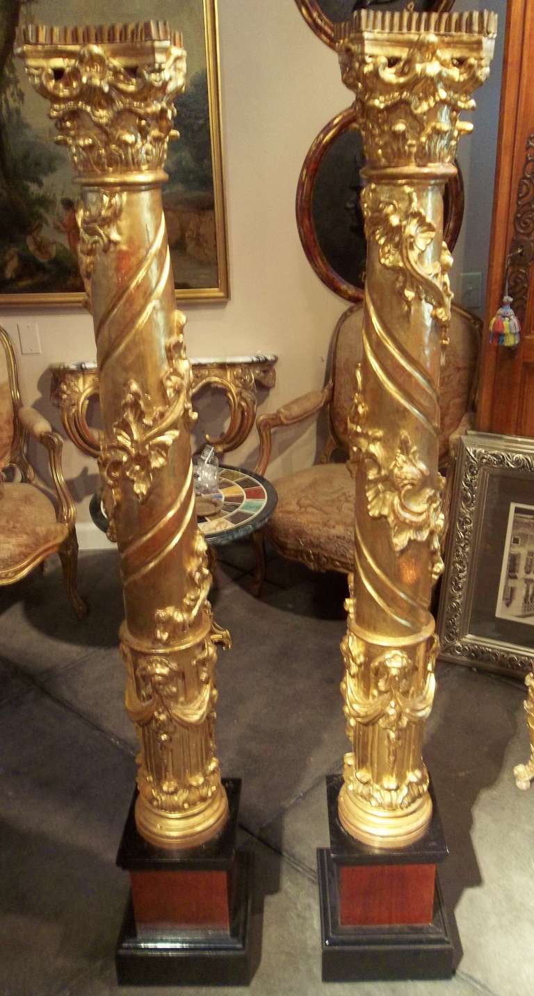 The well carved fronts in water-gilt . The backs while carved are not finished , typical altar or church pieces.Resting upon  later 20th century bases of ebonized wood and red mahogany .  Italian or French

Some bleeding of the red bole basecoat