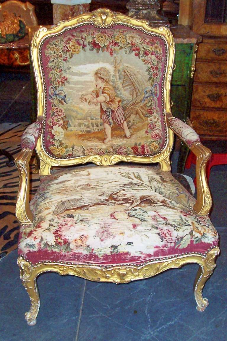 Highly decorative & commodious giltwood chair or fautueil with worn tapestry