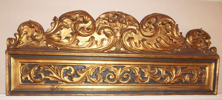 A wood carved and paint and parcel gilt panel possibly an overdoor (or over window) paneling fragment. Deeply and robustly carved and of significant size. 

Italy or France