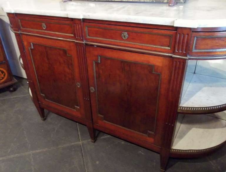 Mahogany dessert with plum pudding mahogany panels inserted into door fronts. 
The mirrored and marble  curved ends beneath swivel drawers . The shaped and beveled carrera marble top in pristine condition .Secondary wood (structural support ) is