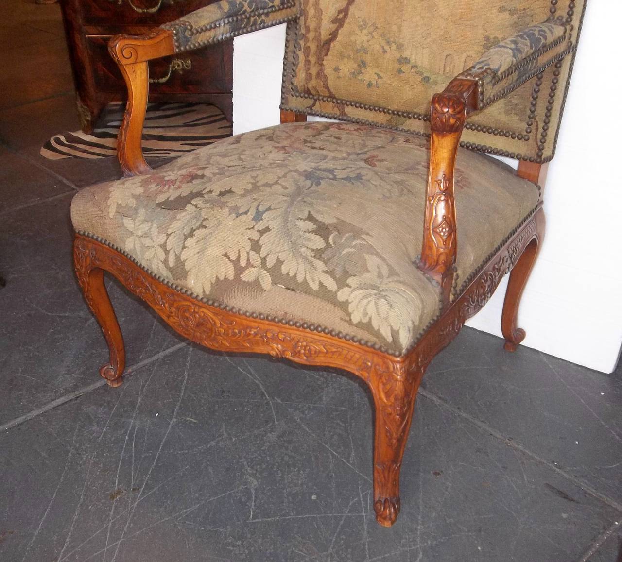 Carved frame in sturdy beechwood with rocaille shells and floral sprays. Tapestry in generally fine condition , typical separations (visible in photo ) to the seat but no tears , splits, or rodent /pest damage . Well tacked decoration and the seat