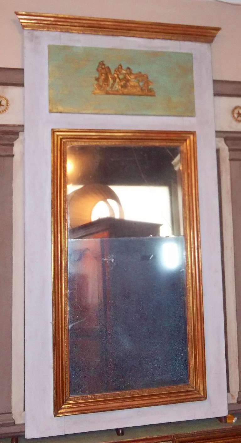 A trumeau frame encasing a gilt decorated bipartite plate mirror .A green /gold washed upper panel is mounted between the mirror and the top rail..

Possibly some later painting to the green panel and later gold wash .

Diamond dust and overall