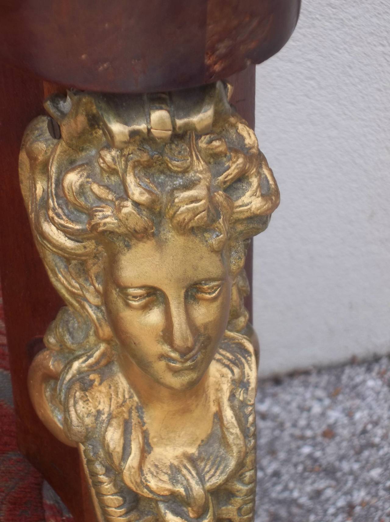 Of generous proportions and presence . The front mounted with well cast bronze mounts (of some size and weight ). The top with French interpretations of the Greek Caryatids (very attractive faces ). Wear and losses to the gilding.Legs ending in