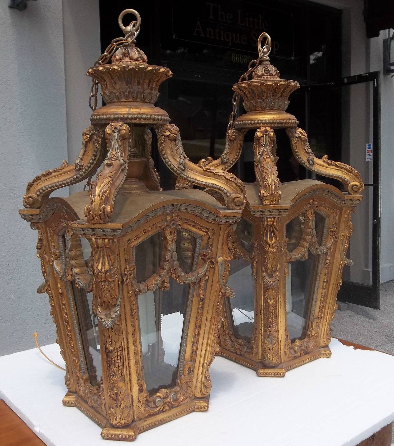 Probably mid-later 20th century, recent wiring. Bevelled glass panes with floral festoons, foliate scrolls. Some gilt paint loss to tops (probably from heat or sunlight). The visible portion in good shape, nice patina, some pastel highlights.